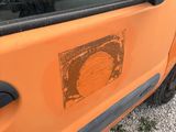 an orange car with a picture on the side of it