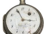 a close up of a pocket watch with roman numerals on it