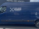 a blue van that is parked in front of a building
