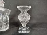 two glass vases sitting next to each other on a table