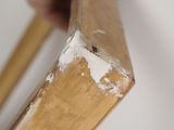 a person that is holding a piece of wood in their hand
