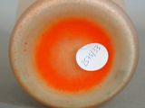 a close up of a vase with a tag on it