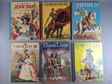 four books of children ' s literature are lined up on a table