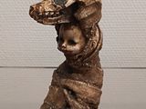 a statue of a bird with a human head on it ' s head