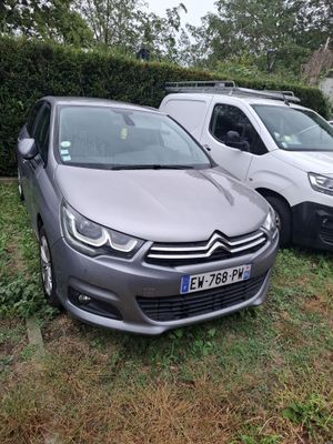 two cars parked next to each other in the grass