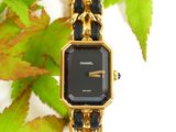 a black and gold watch with a chain around it