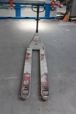 a forklift sitting in the middle of a warehouse floor