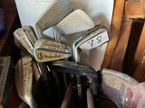 a bucket full of golf clubs sitting on a table