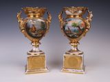 paire de vases anciens ornés de scènes peintes, posés sur des socles en marbre