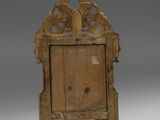 an old wooden chair with a carved back and legs