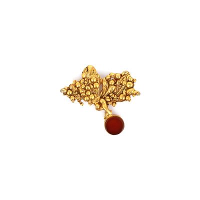 an image of a gold leaf broochle with a red stone