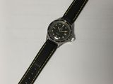 a close up of a watch on a table with a white background