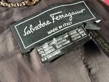 an image of a label on a jacket with a chain on it