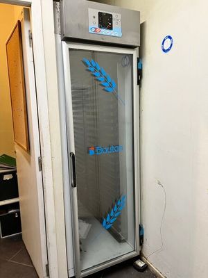 an image of a freezer in a room with a blue sticker on the door