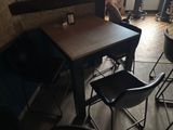 a small table and chairs in a small room