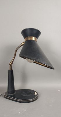 a black lamp that is on a white table