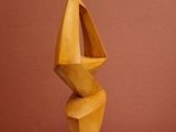 sculpture of a wooden sculpture on a wooden table against a red wall