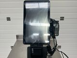 an image of a monitor on a table in front of a garage door