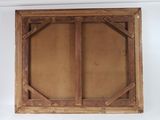 an old wooden frame with a window on a white wall