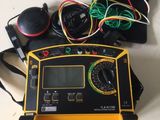 a laptop with a yellow case and wires on the table