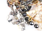 many different types of jewelry on a white surface