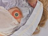 a close up of a doll with an eye patch on it ' s face