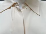 a close up of a white shirt on a mannequin