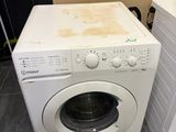 washing machine and dryer sitting on tiled floor in a room