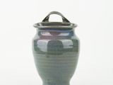 a green vase with a handle on a white background