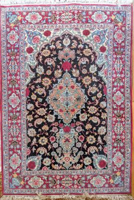 a black and red rug with a floral design on it