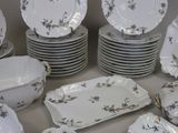 a lot of plates and bowls that are sitting on a table