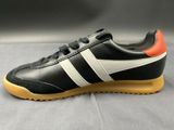 a close up of a pair of black and orange sneakers