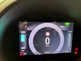 a car dashboard with a digital display showing the speed of the car