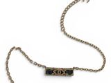 a close up of a necklace with a chain attached to it