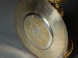 a silver plate with a gold egg on it