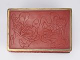 an image of a red and gold box with flowers on it