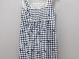 a white and blue dress hanging on a hanger
