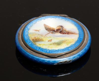 une petite boîte bleue sur laquelle est représenté un oiseau