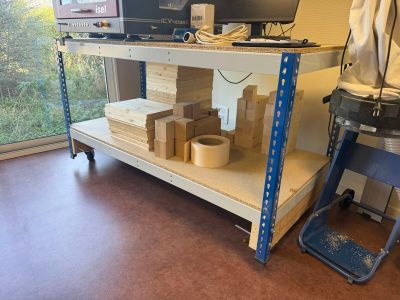 a desk with a computer and some boxes on it