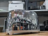 a toaster that is sitting on a table in front of a shelf