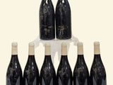 six bottles of wine are arranged in a pyramid on a table