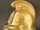 gold helmet on a stand with a black background