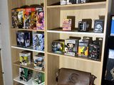 a wooden bookcase filled with various items in a room