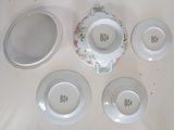 four plates and a bowl on the table