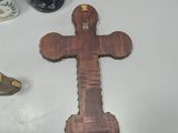 a wooden cross on a table next to a pair of scissors