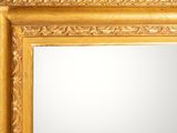 an image of a gold framed mirror on a white wall