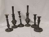 several candles are sitting on a table with a white background