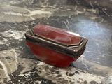 marble table top with a silver and red box on it