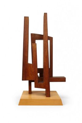 wooden sculpture of a chair on a wooden base on a white background
