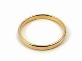 a close up of a gold ring on a white surface